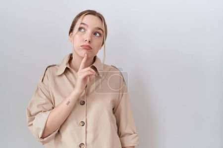 Photo for Young caucasian woman wearing casual shirt thinking concentrated about doubt with finger on chin and looking up wondering - Royalty Free Image