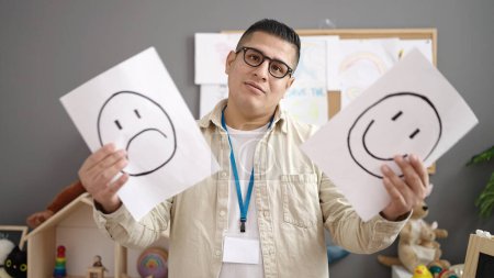 Téléchargez les photos : Young hispanic man working as teacher having emotion therapy at kindergarten - en image libre de droit