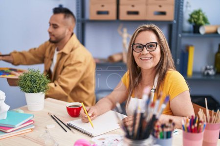 Photo for Man and woman artists smiling confident drawing at art studio - Royalty Free Image