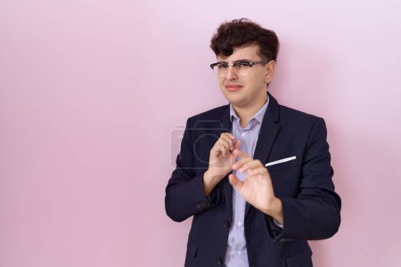 Photo for Young non binary man with beard wearing suit and tie disgusted expression, displeased and fearful doing disgust face because aversion reaction. with hands raised - Royalty Free Image