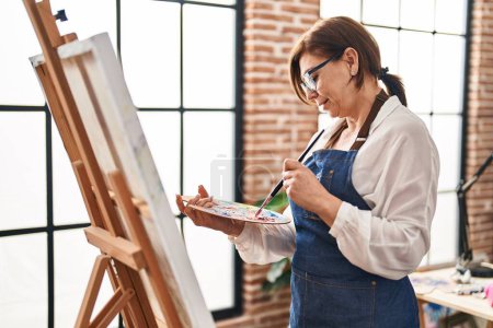 Photo for Middle age woman artist smiling confident drawing at art studio - Royalty Free Image