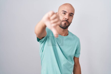 Photo for Middle age bald man standing over white background looking unhappy and angry showing rejection and negative with thumbs down gesture. bad expression. - Royalty Free Image