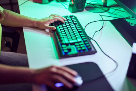 Photo for Young blonde woman using computer keyboard and mouse at gaming room - Royalty Free Image