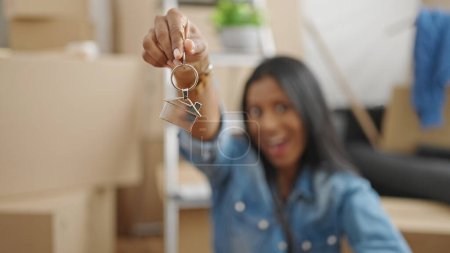 Photo for African american woman smiling confident holding keys at new home - Royalty Free Image
