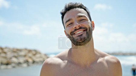 Photo for Young hispanic man tourist smiling confident shirtless at the beach - Royalty Free Image