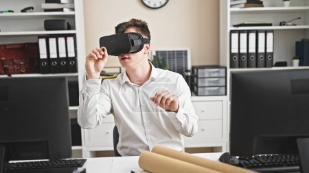 Photo for Young hispanic man architect wearing virtual reality glasses drawing at office - Royalty Free Image