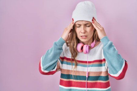 Photo for Young blonde woman standing over pink background with hand on head for pain in head because stress. suffering migraine. - Royalty Free Image