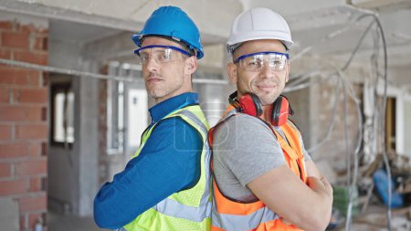 Photo for Two men builders smiling confident standing with arms crossed gesture at construction site - Royalty Free Image