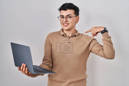 Photo for Non binary person using computer laptop looking confident with smile on face, pointing oneself with fingers proud and happy. - Royalty Free Image