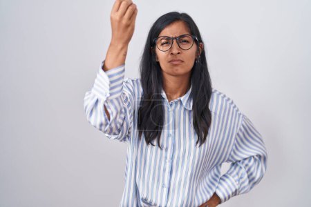 Foto de Young hispanic woman wearing glasses doing italian gesture with hand and fingers confident expression - Imagen libre de derechos