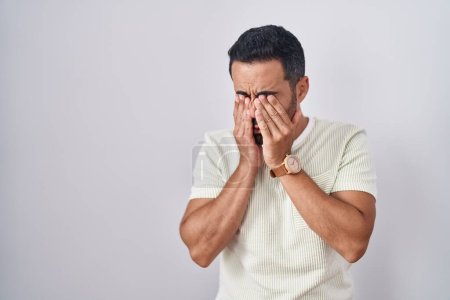 Photo for Hispanic man with beard standing over isolated background rubbing eyes for fatigue and headache, sleepy and tired expression. vision problem - Royalty Free Image