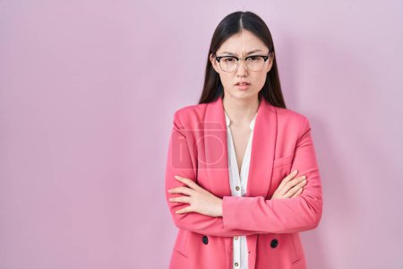 Photo for Chinese business young woman wearing glasses skeptic and nervous, disapproving expression on face with crossed arms. negative person. - Royalty Free Image