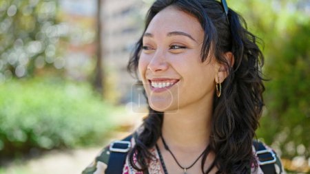 Photo for Young beautiful hispanic woman smiling confident looking to the side at park - Royalty Free Image