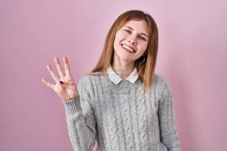 Photo for Beautiful woman standing over pink background showing and pointing up with fingers number four while smiling confident and happy. - Royalty Free Image