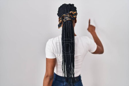Photo for Beautiful black woman standing over isolated background posing backwards pointing ahead with finger hand - Royalty Free Image