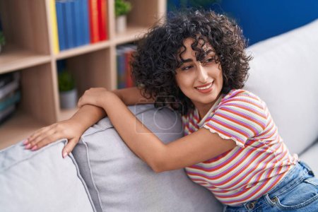 Photo for Young middle eastern woman smiling confident sitting on sofa at home - Royalty Free Image