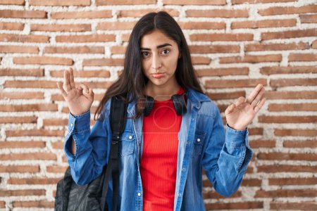 Photo for Young teenager girl wearing student backpack doing relax sign depressed and worry for distress, crying angry and afraid. sad expression. - Royalty Free Image