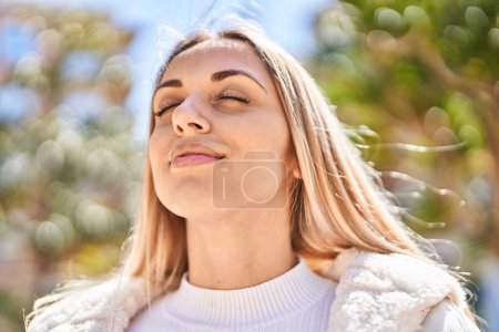Photo for Young woman smiling confident breathing at park - Royalty Free Image