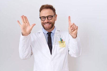Foto de Middle age doctor man with beard wearing white coat showing and pointing up with fingers number six while smiling confident and happy. - Imagen libre de derechos