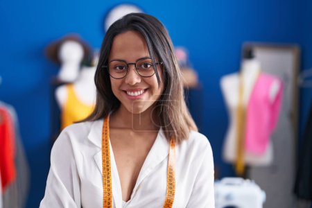 Téléchargez les photos : Young hispanic woman tailor smiling confident standing at sewing studio - en image libre de droit