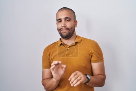 Photo for Hispanic man with beard standing over white background disgusted expression, displeased and fearful doing disgust face because aversion reaction. - Royalty Free Image