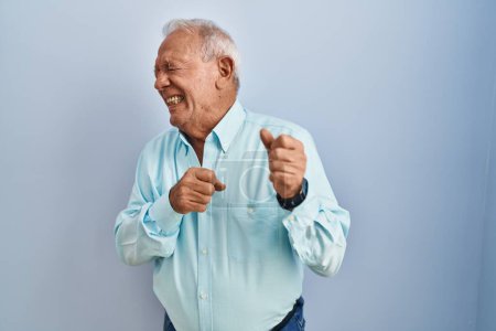 Photo for Senior man with grey hair standing over blue background disgusted expression, displeased and fearful doing disgust face because aversion reaction. with hands raised - Royalty Free Image