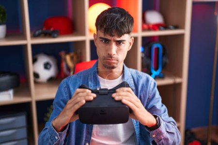 Photo for Young hispanic man wearing virtual reality glasses skeptic and nervous, frowning upset because of problem. negative person. - Royalty Free Image