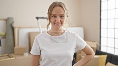 Photo for Young blonde woman smiling confident standing at new home - Royalty Free Image