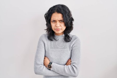 Photo for Hispanic woman with dark hair standing over isolated background skeptic and nervous, disapproving expression on face with crossed arms. negative person. - Royalty Free Image