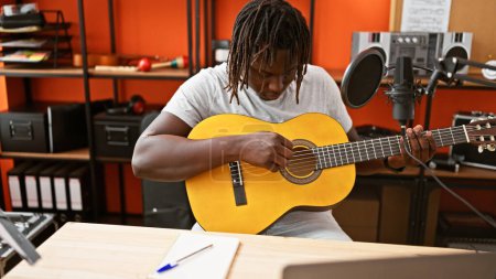 Photo for African american man musician playing classical guitar at music studio - Royalty Free Image