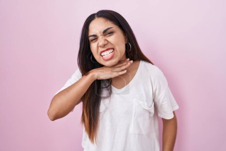 Photo for Young arab woman standing over pink background cutting throat with hand as knife, threaten aggression with furious violence - Royalty Free Image