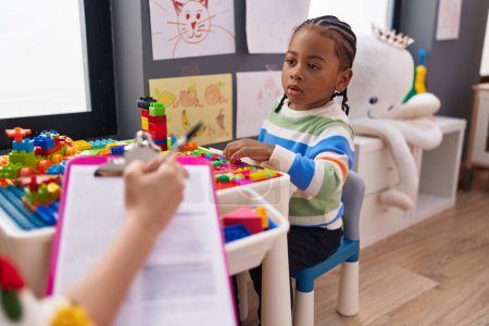 Photo for African american boy playing with construction blocks having psychotherapy at kindergarten - Royalty Free Image