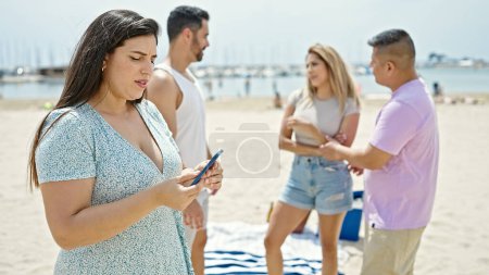 Photo for Group of people using smartphone at beach - Royalty Free Image