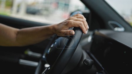 Photo for Middle age hispanic woman driving a car on the road - Royalty Free Image