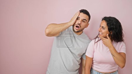 Photo for Man and woman couple standing together with surprise expression over isolated pink background - Royalty Free Image