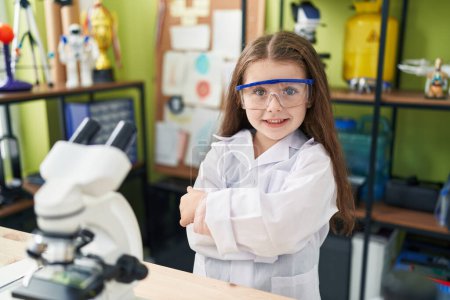 Photo for Adorable hispanic girl student smiling confident standing with arms crossed gesture at laboratory classroom - Royalty Free Image
