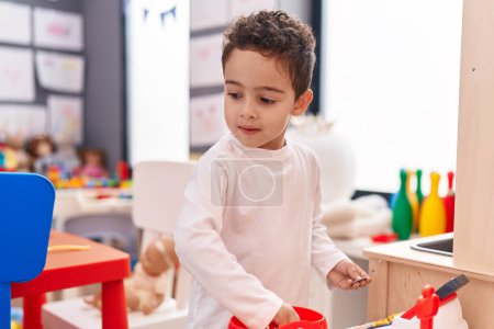 Photo for Adorable hispanic boy playing supermarket game standing at kindergarten - Royalty Free Image