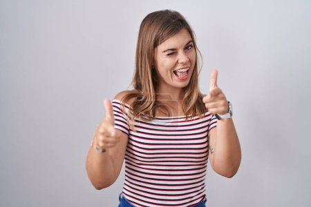 Photo for Young hispanic woman standing over isolated background pointing fingers to camera with happy and funny face. good energy and vibes. - Royalty Free Image