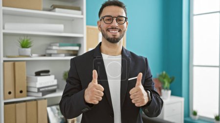 Photo for Young arab man business worker doing thumbs up gesture at the office - Royalty Free Image