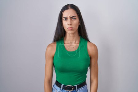 Photo for Young woman standing over isolated background skeptic and nervous, frowning upset because of problem. negative person. - Royalty Free Image