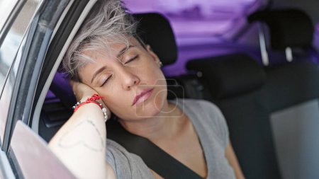 Photo for Young woman passenger sitting on car sleeping at street - Royalty Free Image