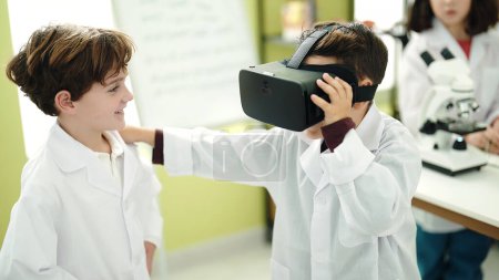 Photo for Adorable boys scientist student using virtual reality glasses at laboratory classroom - Royalty Free Image