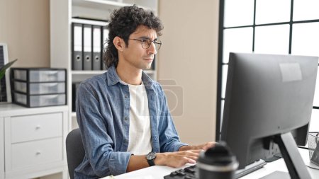 Photo for Young hispanic man business worker using computer working at office - Royalty Free Image
