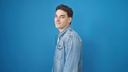 Photo for Young hispanic man smiling confident standing over isolated blue background - Royalty Free Image