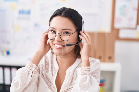 Photo for Young hispanic woman call center agent having video call at street - Royalty Free Image