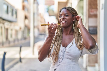 Photo for African american woman smiling confident talking on the smartphone at street - Royalty Free Image