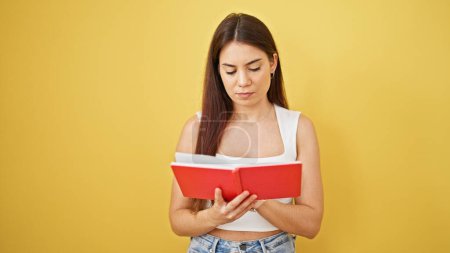 Photo for Young beautiful hispanic woman reading book thinking over isolated yellow background - Royalty Free Image