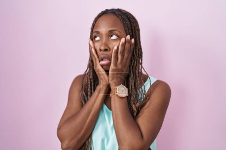 Photo for African american woman standing over pink background tired hands covering face, depression and sadness, upset and irritated for problem - Royalty Free Image