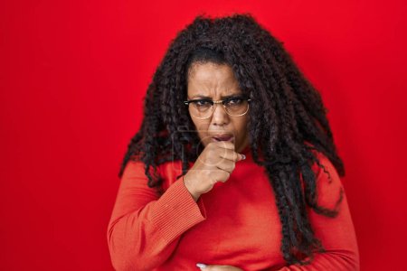 Photo for Plus size hispanic woman standing over red background feeling unwell and coughing as symptom for cold or bronchitis. health care concept. - Royalty Free Image