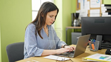 Photo for Young beautiful hispanic woman business worker using laptop at office - Royalty Free Image